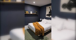 A modern bedroom with a bed, a checkered floor, and a dark wall. - Stylish 1BDR in the heart of Trendy Fitzroy (Melbourne)