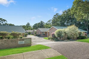 homes with pitched roofs and brick exteriors set amidst well-maintained lawns and mature trees.