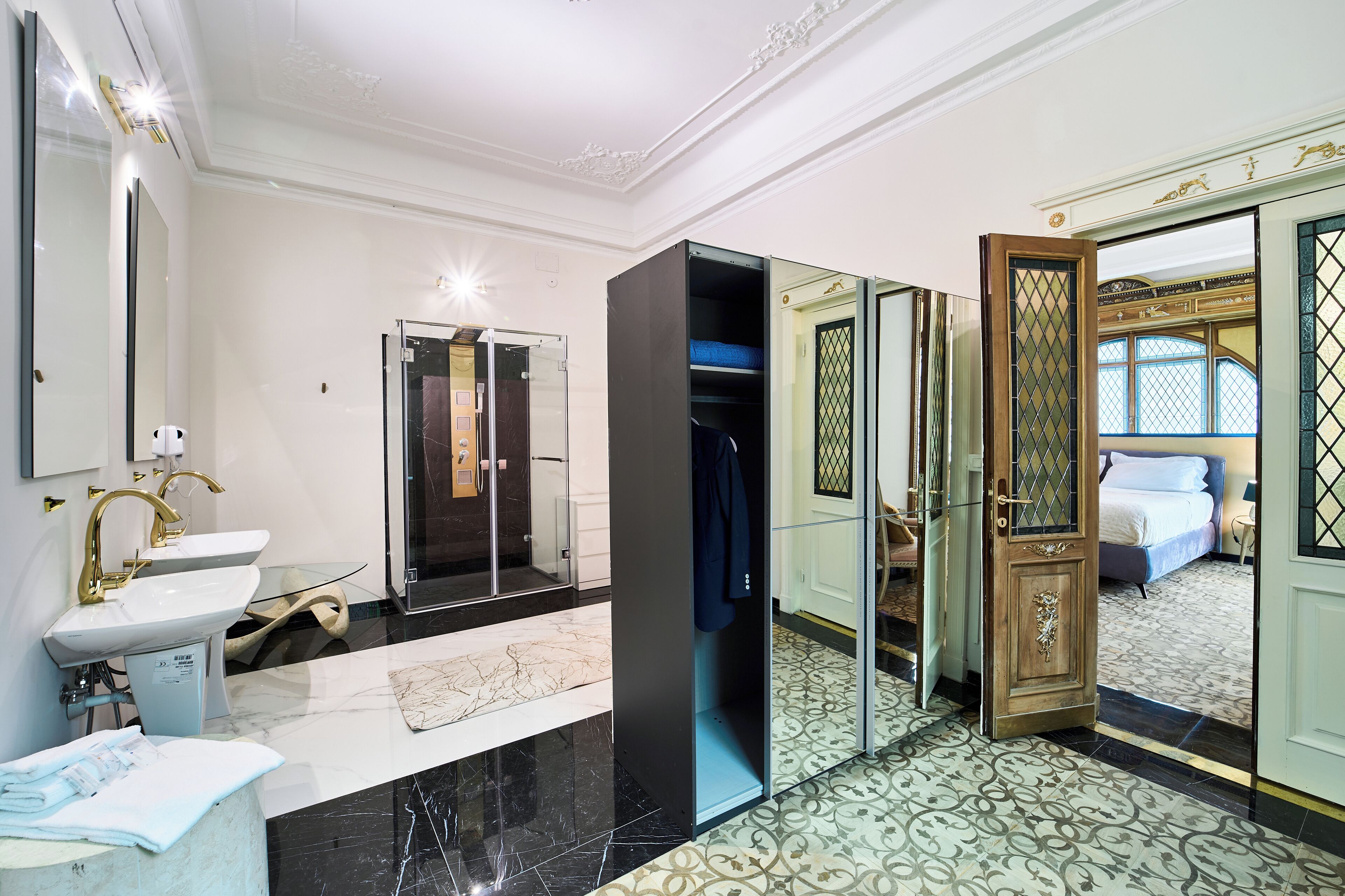 A modern bathroom with a sink, mirror, and shower.