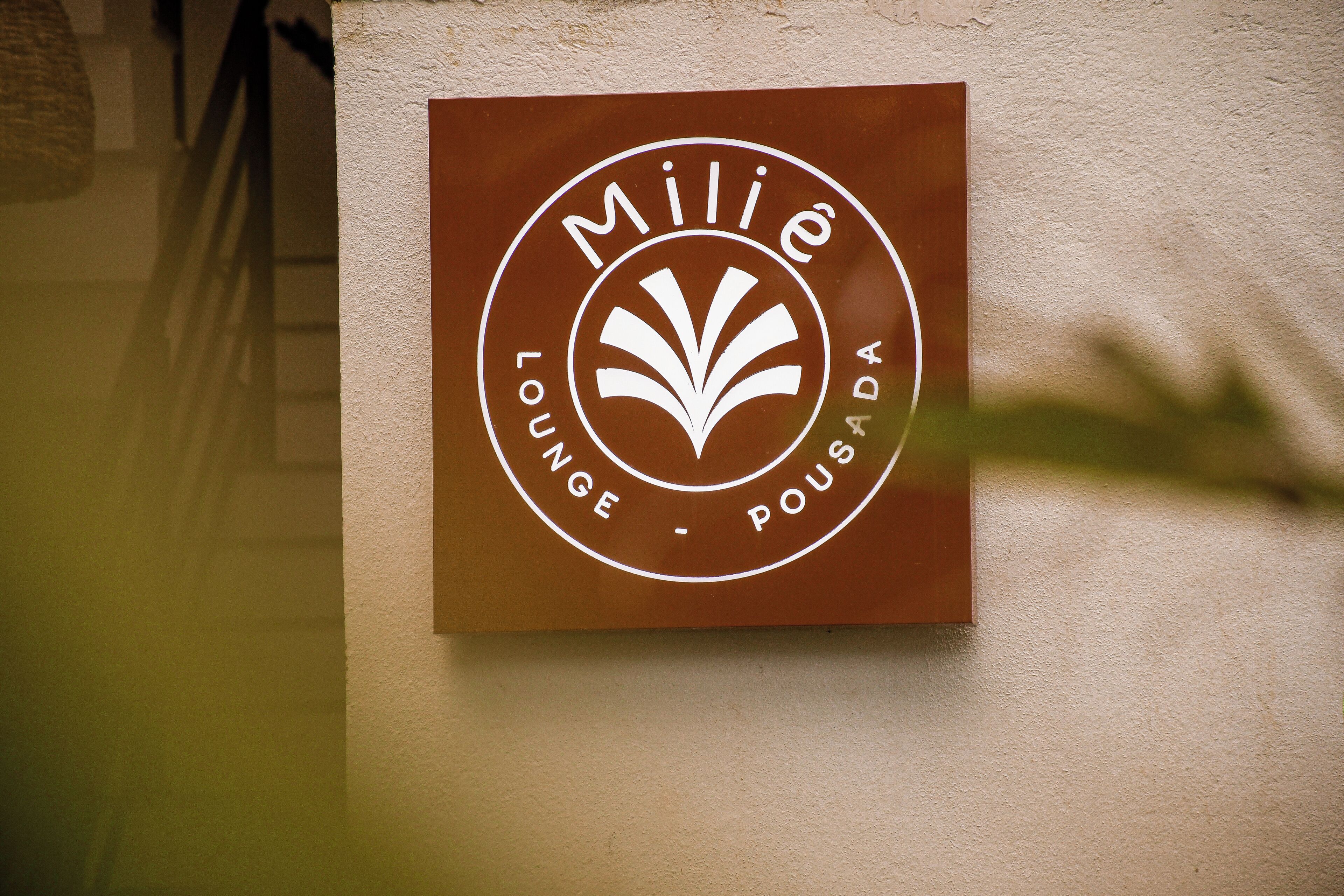 A sign for "Mille Lounge - Poujade" on a wall.