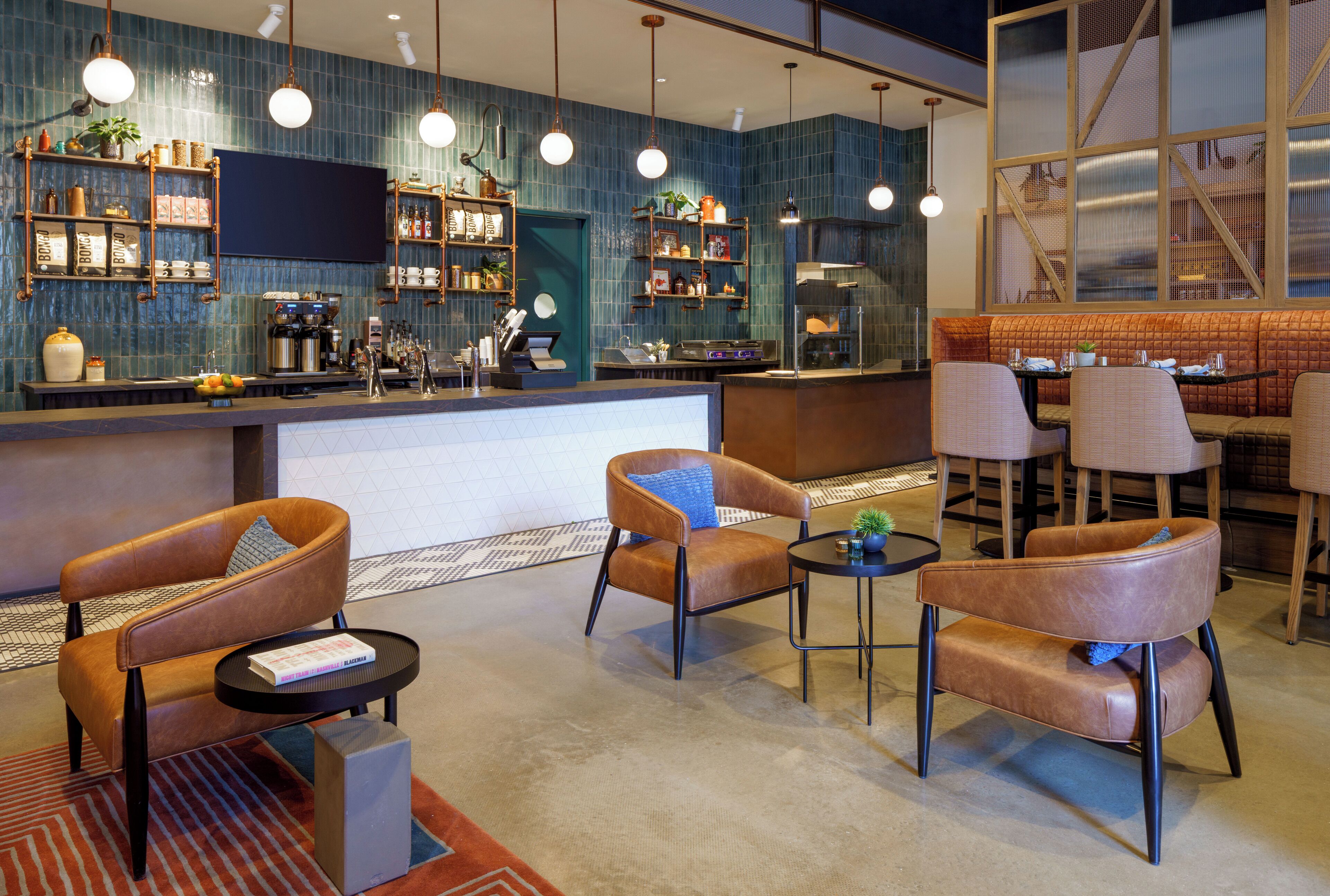 A modern bar area with seating, a counter, and various amenities.