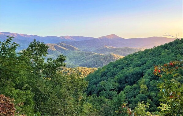 A mountainous landscape with dense forest coverage and distant mountain ranges. - NEW Renovated Fabulous 2 bed 2 Bath Pool View (Gatlinburg)