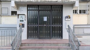 A building entrance with a metal gate, a staircase leading up to the entrance, and a sign above the gate. - Cabeceo in Jerez de la Frontera (Jerez de la Frontera)