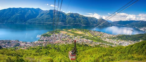 A cable car system with a view of a lake and mountains in the background.