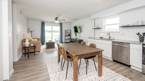 A modern kitchen with white cabinets, a stainless steel dishwasher, and a granite countertop. - StayBurgundy Fairfield, OH (Fairfield)