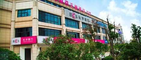 A multi-story building with signage for a medical facility and a pharmacy.