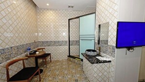 A bathroom with a tiled floor, a sink, a mirror, and a television. - Changsha Xingangwan Hotel (Changsha)