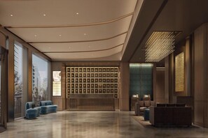A modern lobby with a reception desk, seating area, and a wall of framed pictures. - Crystal Orange (Shanghai Oriental Pearl Binjiang) (Shanghai)