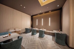 A modern hotel room with a herringbone floor pattern, a large window, and a seating area with a sofa and chairs. - Crystal Orange (Shanghai Oriental Pearl Binjiang) (Shanghai)
