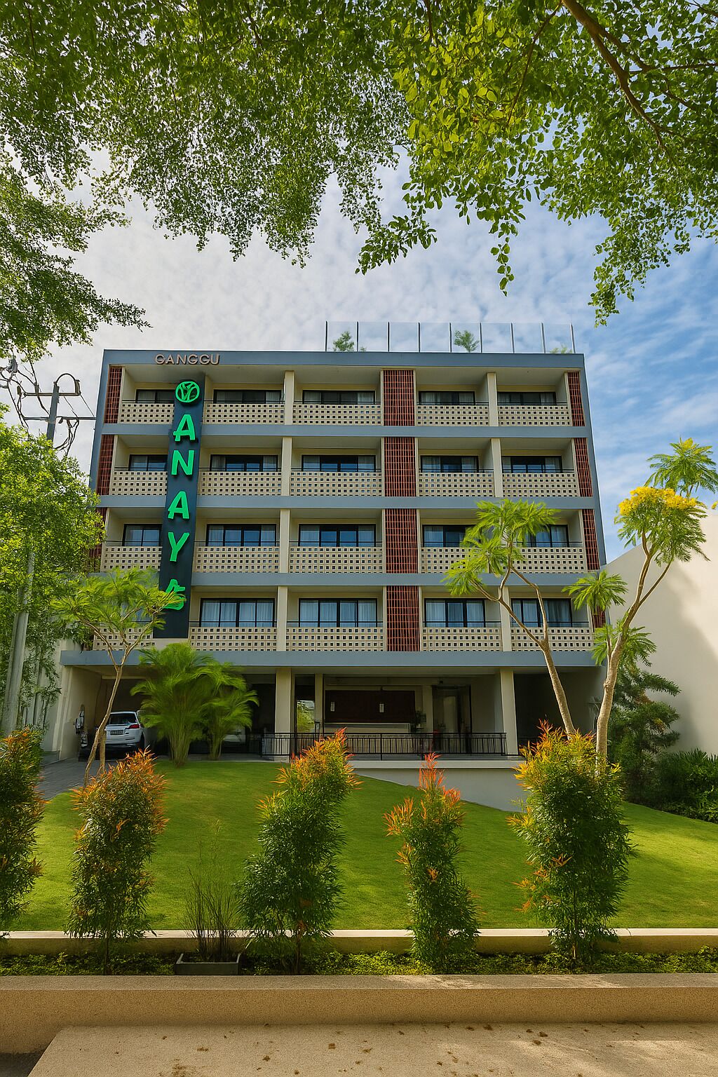 A multi-story hotel with a prominent green sign reading "GANCU ANAY".