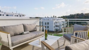 A rooftop terrace with a sofa, chairs, and a table. - Apartment La Cala With Pool (Mijas)