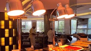 A buffet area with various food items and a chef preparing food. - Shanghai Changxing International Hotel (Shanghai)