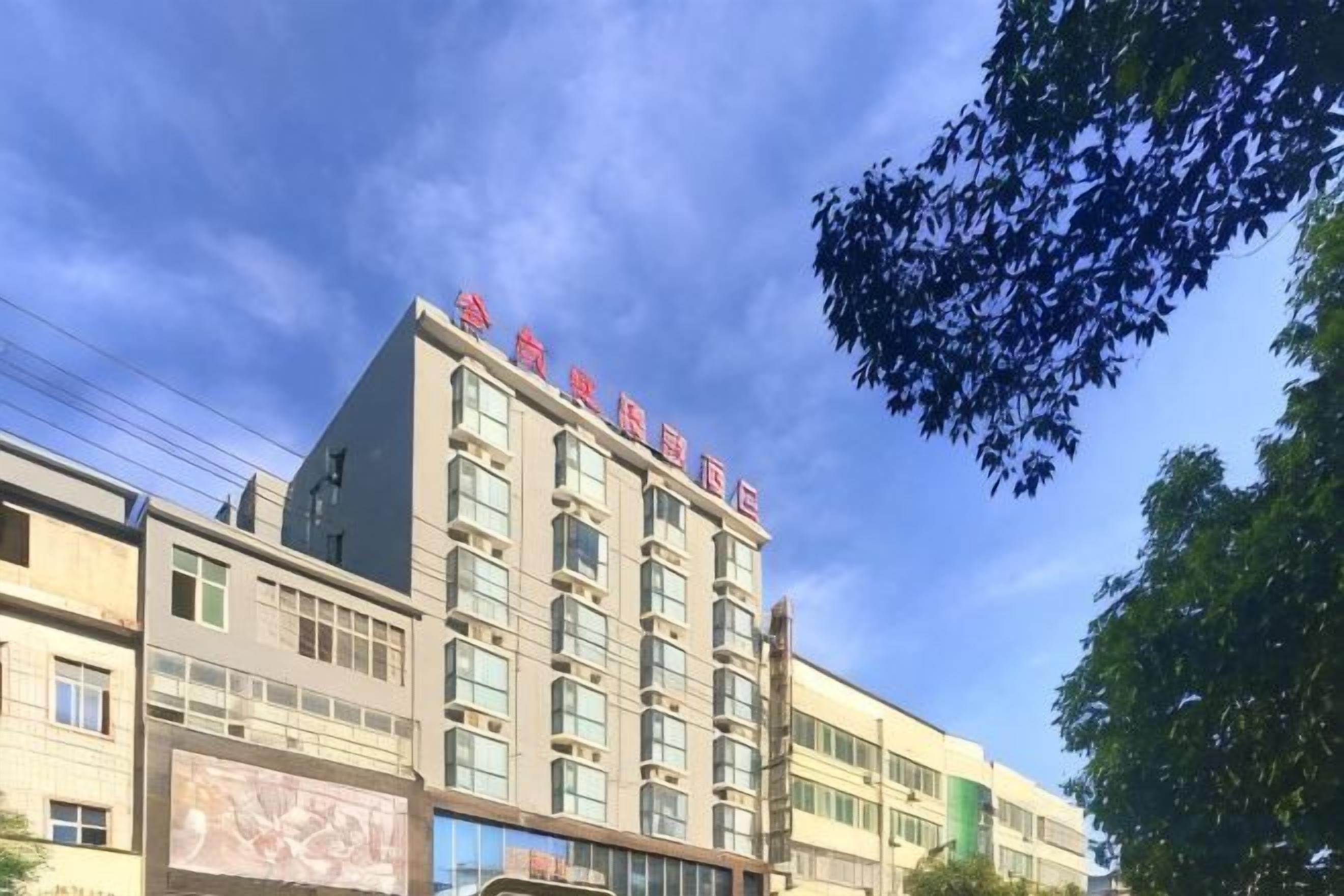 A multi-story building with a prominent sign on the top.