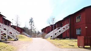 A pathway leading to red buildings with white staircases. - Forenom Serviced Apartments Porvoo (Porvoo)