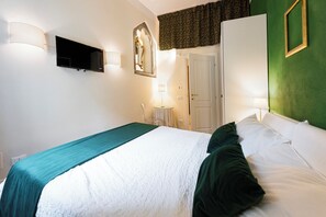 Relax in this inviting space with a comfortable bed, flat-screen TV, and convenient table for your stay.