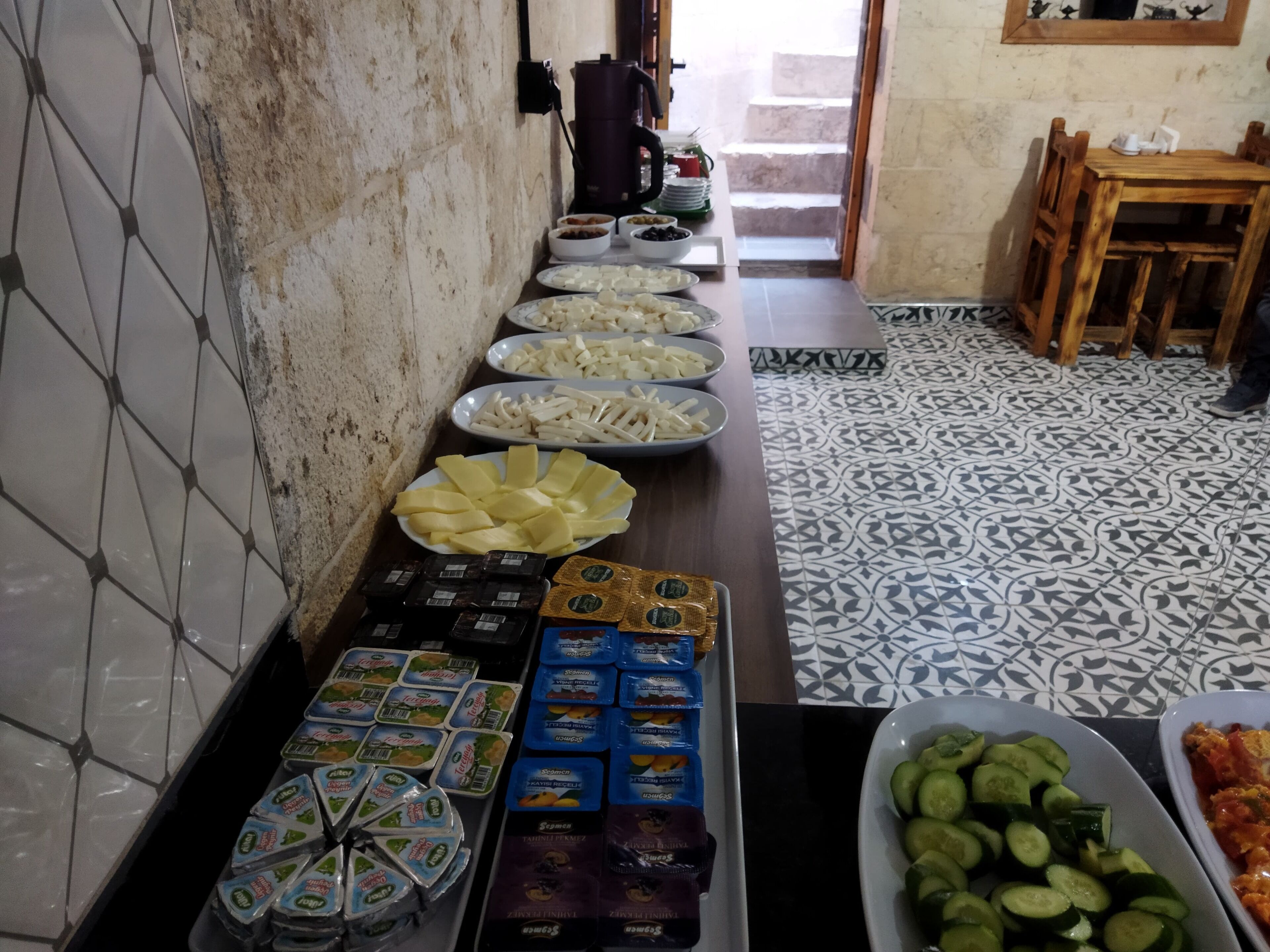 A buffet setup with various food items and condiments.