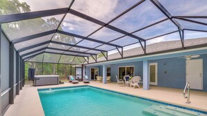 A covered swimming pool with a glass ceiling, lounge chairs, and a small seating area. - Near State Parks! Crystal River Home w/ Hot Tub (Crystal River)