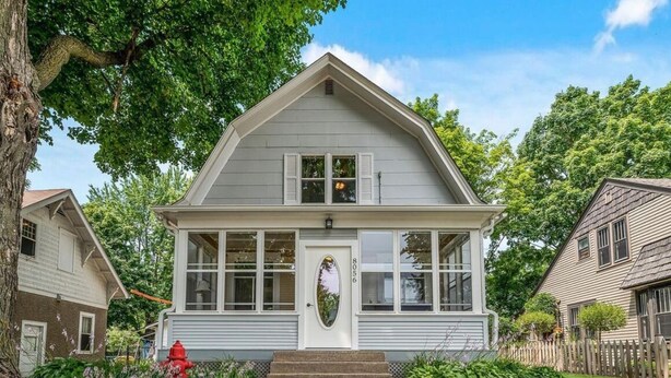 A two-story house with a gabled roof, a front porch, and a front yard with a red fire hydrant. - Heron House - Elevated Vintage Downtown Victoria (Victoria)