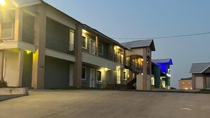 A multi-story building with balconies and a covered entrance. - MG INN & SUITES (Zapata)