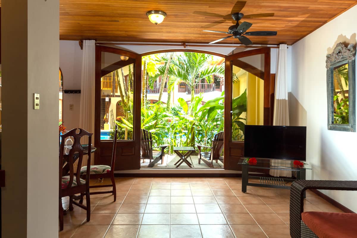 Basic Apartment, Garden View | Living area | 40-inch Smart TV with satellite channels