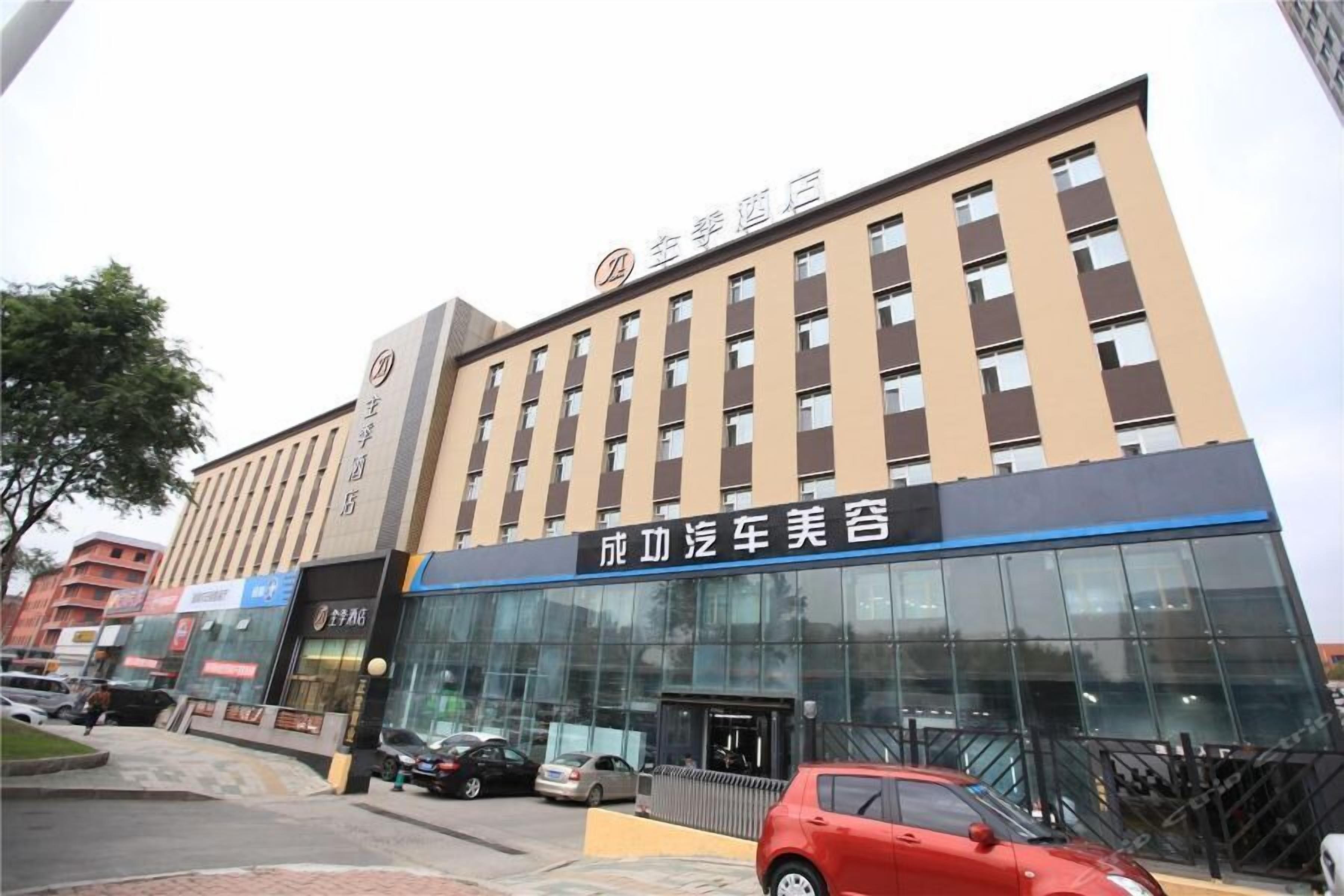 A hotel building with a sign for "Zhongxin Hotel" and a car dealership named "Success Car Beauty Salon" on the ground floor.