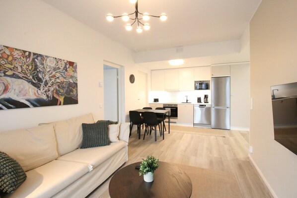 Un appartement moderne comprenant un salon, un coin repas et une cuisine.