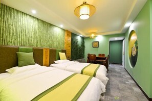 Ein Hotelzimmer mit zwei Betten, einem Schreibtisch und einem Sessel.