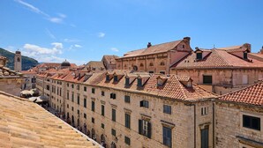 A row of historic stone buildings with red-tiled roofs and multiple windows. - 3 TUDISI LUX SUITES by DOMINIUM deluxe double room (loft) (Dubrovnik)