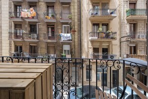 A multi-story building with balconies, some with plants and laundry. - BeBarceloner Badal Apartments - 2 bedrooms (Barcelona)
