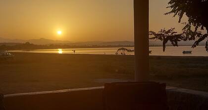 Charming beachfront 2-bedroom house with AC and WiFi.