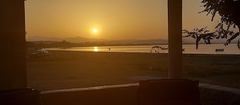Charming beachfront 2-bedroom house with AC and WiFi.