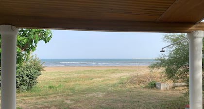 Charming beachfront 2-bedroom house with AC and WiFi.