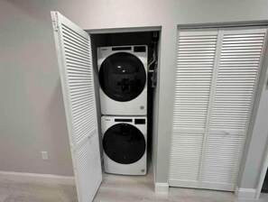 Convenient laundry facilities with two front-loading washing machines.