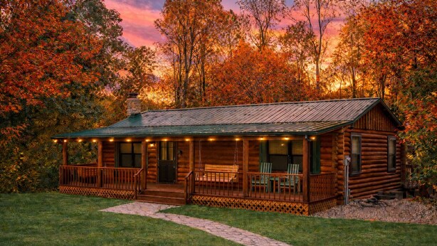 A log cabin with a porch, two windows, and a chimney. - Havenbrook~Rustic luxury, 10acres, hot tub (New Plymouth)