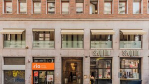 Un immeuble abritant plusieurs commerces, notamment un service de transfert d’argent et une pizzeria.