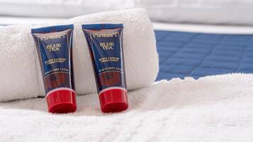 Two tubes of Blue Tea body lotion on a white towel.