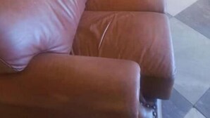 A brown leather sofa against a yellow wall with a tiled floor. - Pvalley Suite 10B 1 Bedroom (Hatfield)