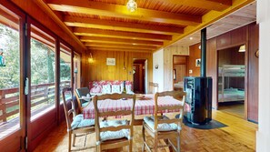 Cozy cabin-style room with a dining area, bunk bed, and heating.