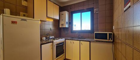 Fridge, microwave, cookware/dishes/utensils