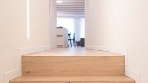 A staircase leading to a room with a desk and chair, a window, and a ceiling with recessed lighting. - Apartment 'Flat 4' with Lake View, Wi-Fi and Air Conditioning (Salò)
