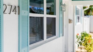 A building with the number 2741, white exterior walls, and teal shutters. - Modern 2BR-Hot Tub/Pergola/Games (West Palm Beach)