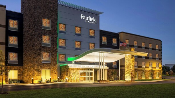 A Fairfield by Marriott hotel with a stone facade, multiple windows, and a covered entrance. - Fairfield Inn & Suites by Marriott® Bethlehem Lehigh (Bethlehem)