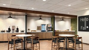 A modern cafe with wooden furniture, a counter with beverages, and a 'Hello Fall' sign. - Fairfield Inn & Suites by Marriott® Bethlehem Lehigh (Bethlehem)