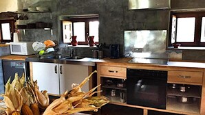 A modern kitchen with a microwave, stove, and dishwasher. - Country House 'La Casa Del Chileno' with Sea View, Private Terrace and Private Garden (Lierganes)