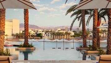 Outdoor pool, open 9:00 AM to 6:30 PM, pool umbrellas, pool loungers