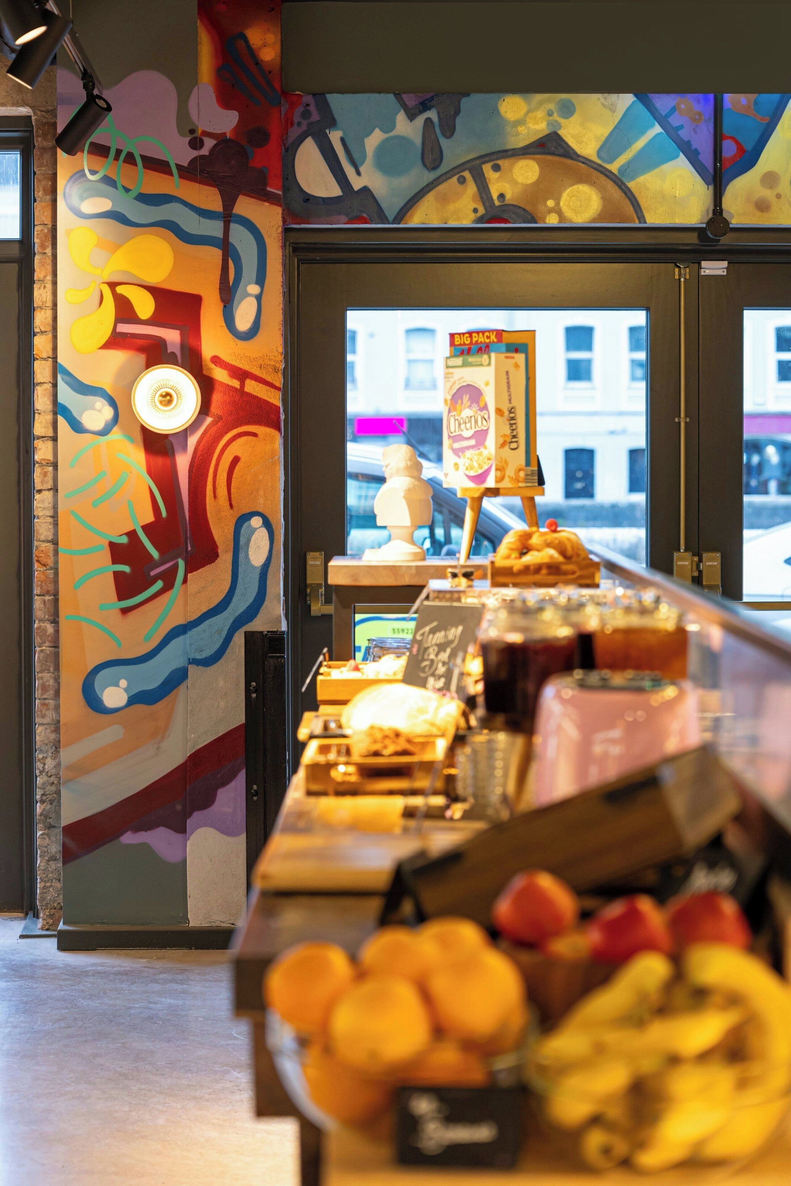 A bakery counter with various baked goods and a chalkboard menu.