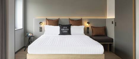 Un dormitorio moderno con una cama grande, una mesita de noche y una puerta corredera.