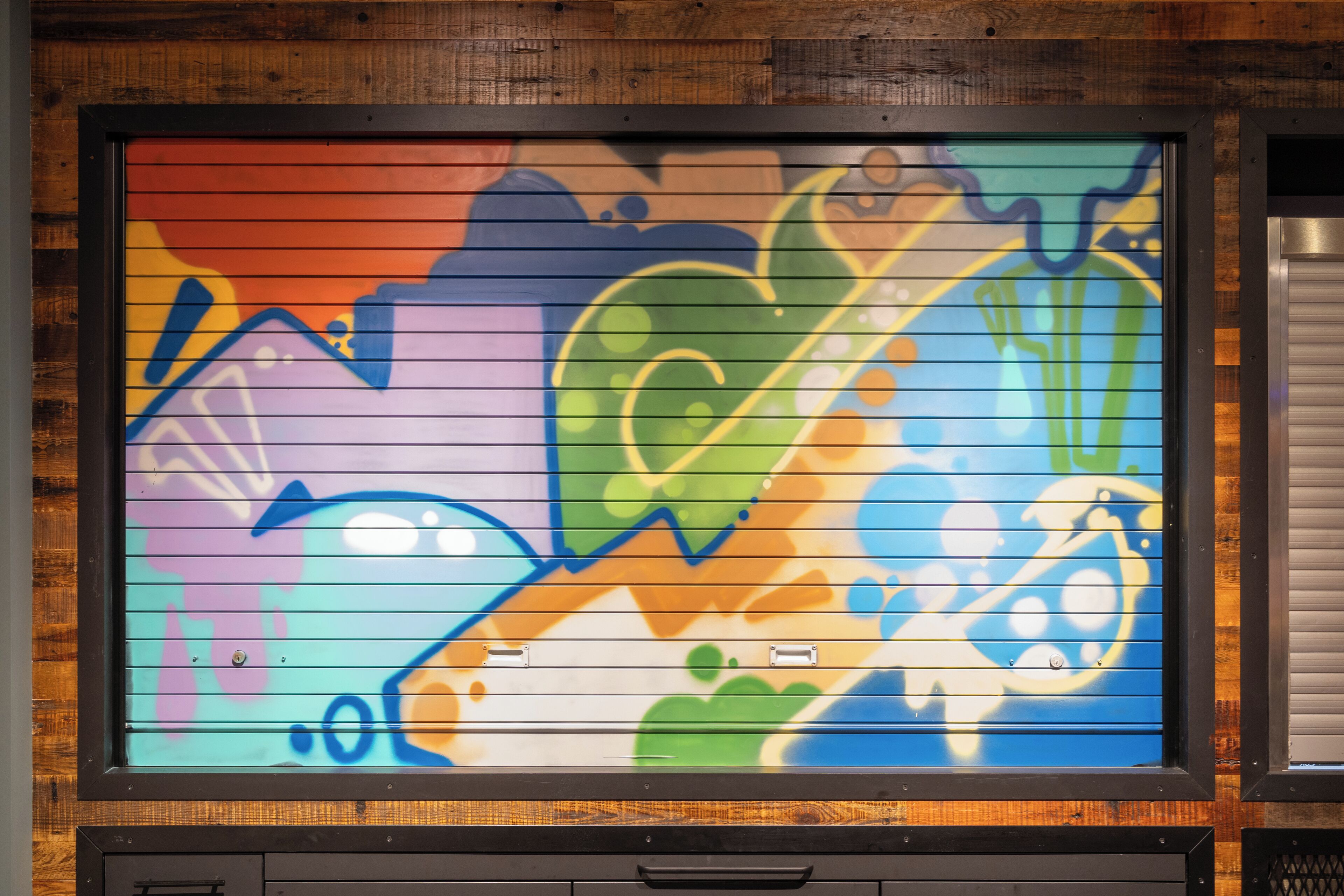 A colorful mural with abstract designs and shapes.