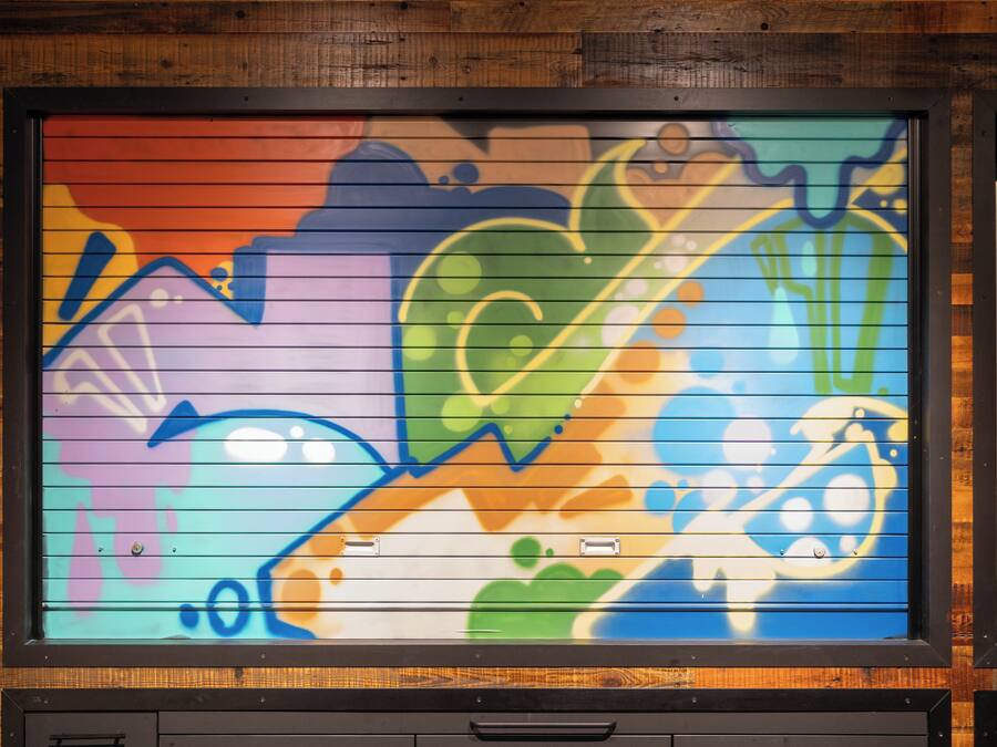 A colorful mural with abstract designs and shapes.