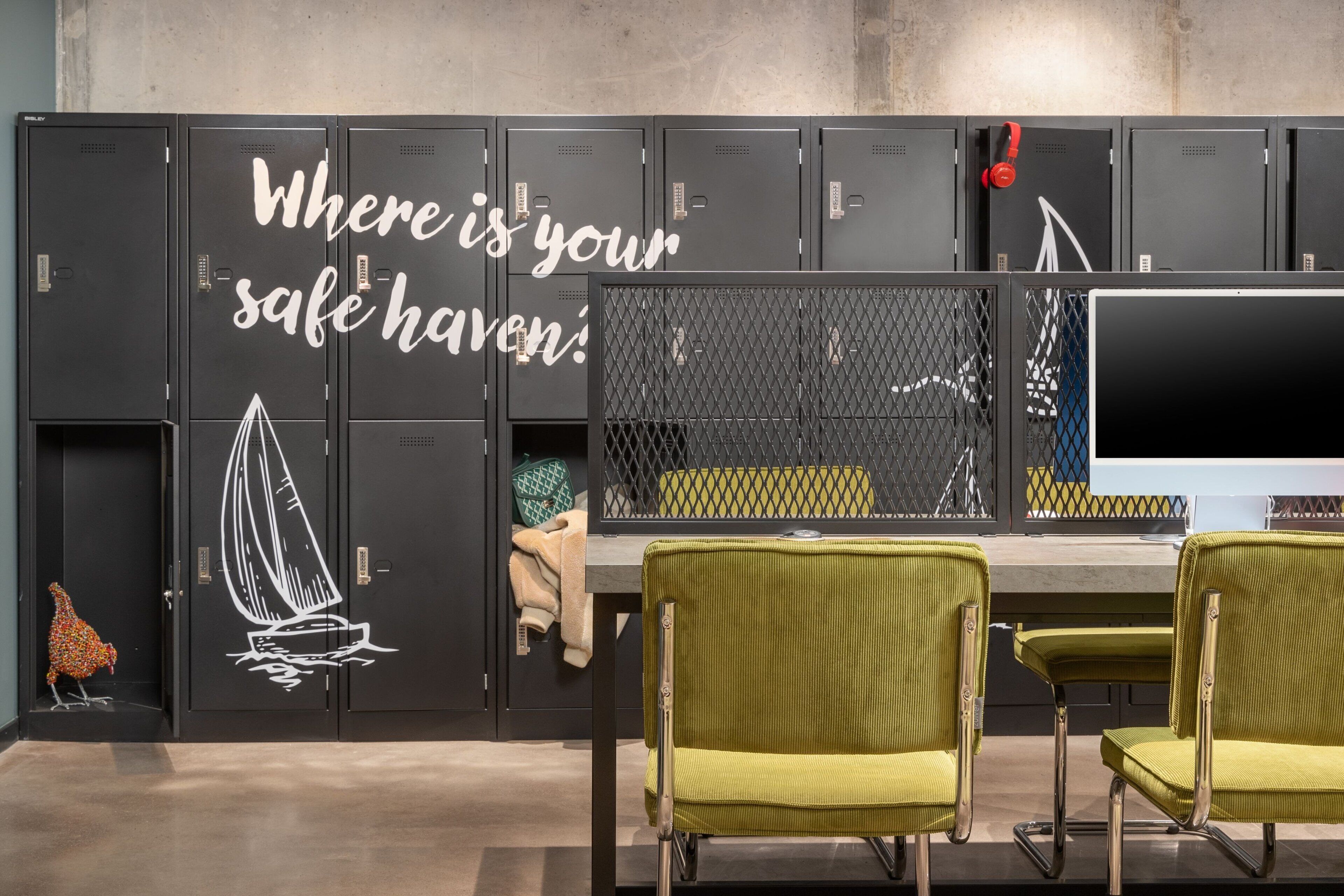 A locker room with lockers, a table, and chairs.